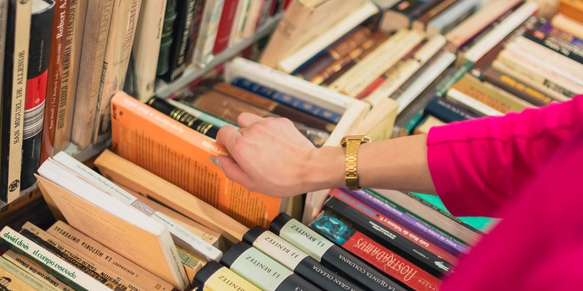 A reader explores a vast collection of books, seeking their next great fantasy adventure.