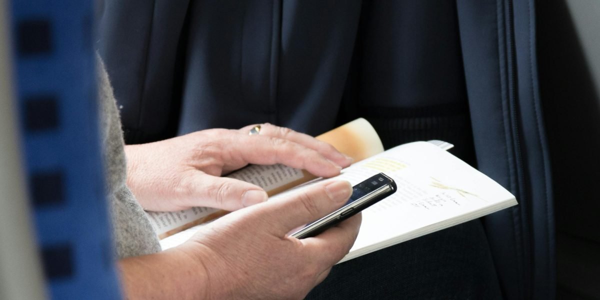 A person engaged in reading a book, representing a reader delving into political literature.
