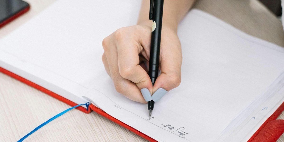 A person actively taking notes, symbolizing the thoughtful approach to planning a reading journey through a long series.