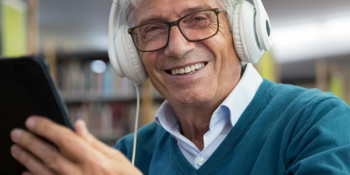 A person happily browsing the shelves of a library, exploring options for finding new books.
