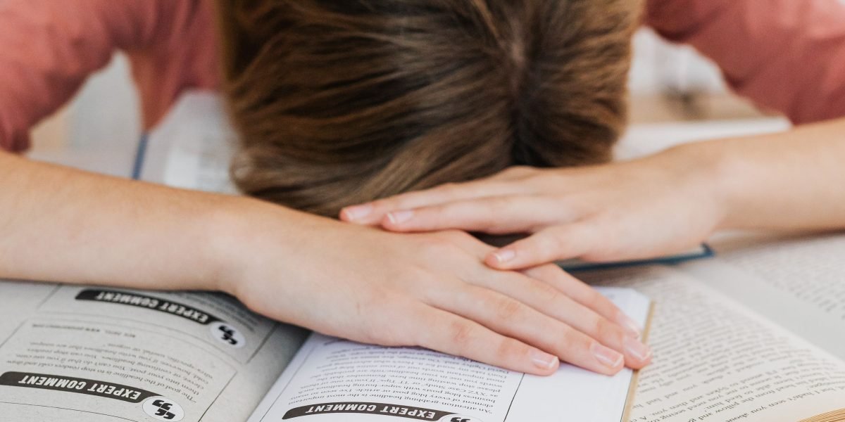 A reader contemplates a large bookshelf, feeling overwhelmed by choices.