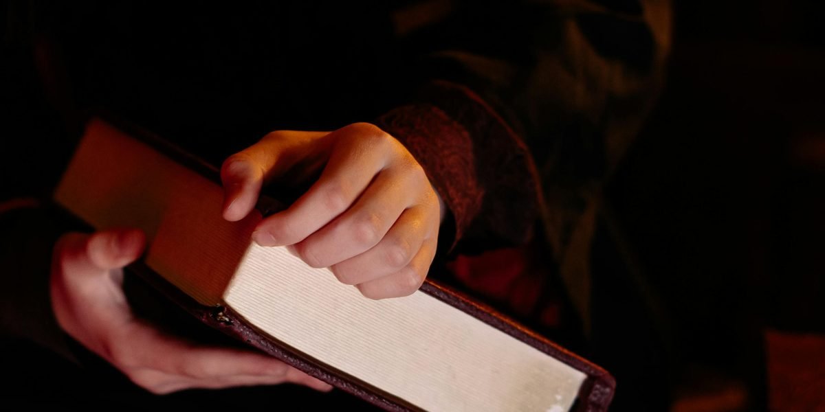 A reader immersed in a captivating young adult fantasy novel, experiencing the thrill of a compelling storyline.
